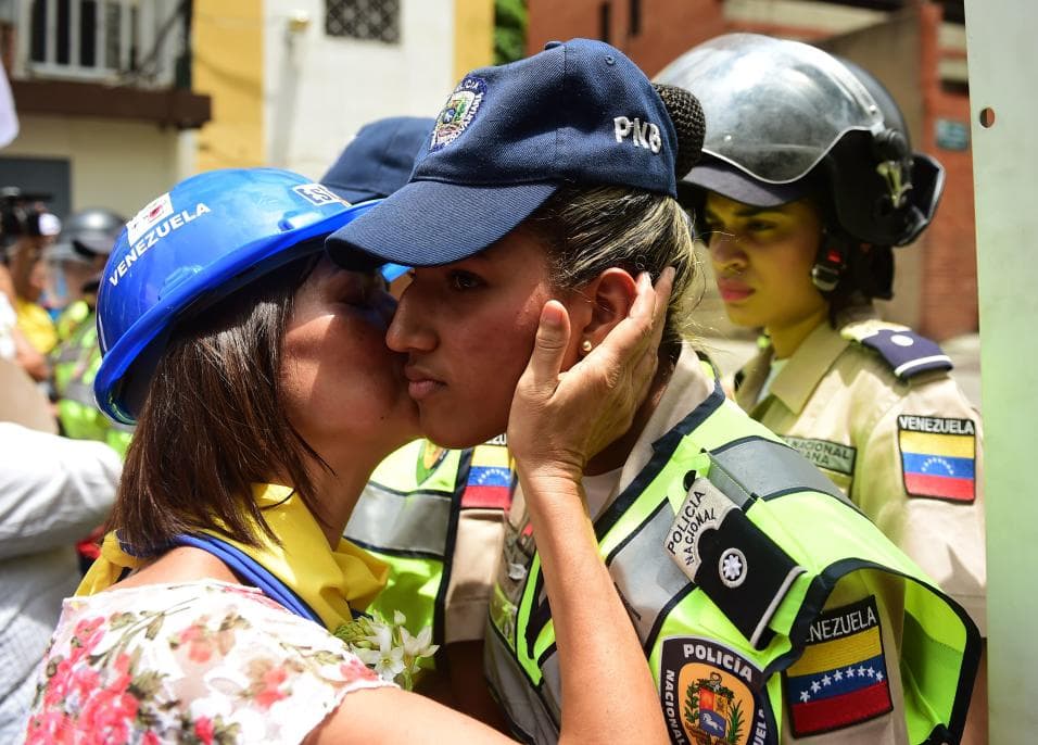 It's not all confrontational. This woman protester kissed a policewoman in a gesture of reconciliation.