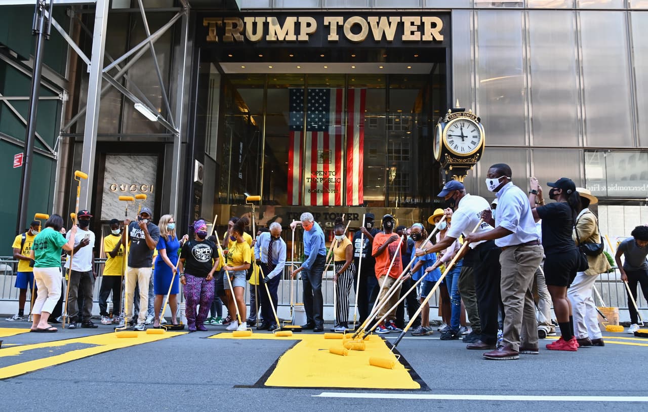 Acompañado de activistas y empleados de la ciudad, Bill de Blasio, alcalde de de Nueva York, tomó un rodillo con pintura para escribir ‘Black Lives Matter’ (‘las vidas de los afroestadounidenses importan’, en español). La frase fue escrita en grandes letras amarillas justo al frente de la torre Trump, en la quinta avenida de Manhattan.