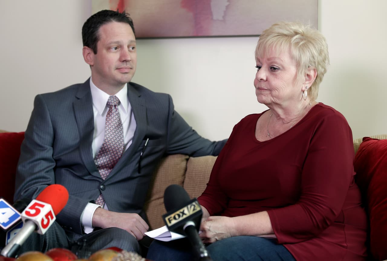 Deborah Giannecchini, right, speaks along side her attorney, Wylie Blair, during a news conference Friday, Oct. 28, 2016, in St. Louis. A jury has awarded Giannecchini more than $70 million in her lawsuit alleging that years of using Johnson & Johnson's baby powder caused her cancer, the latest case raising concerns about the health ramifications of extended talcum powder use. (AP Photo/Jeff Roberson)