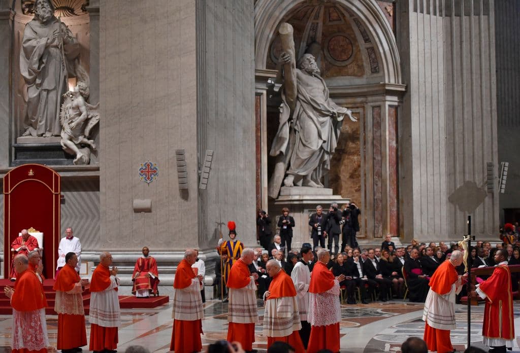 Decenas de cardenales hacen fila para tener su turno de besar un crucifijo durante la ceremonia de Viernes Santo oficiada por el papa Francisco en el Vaticano.