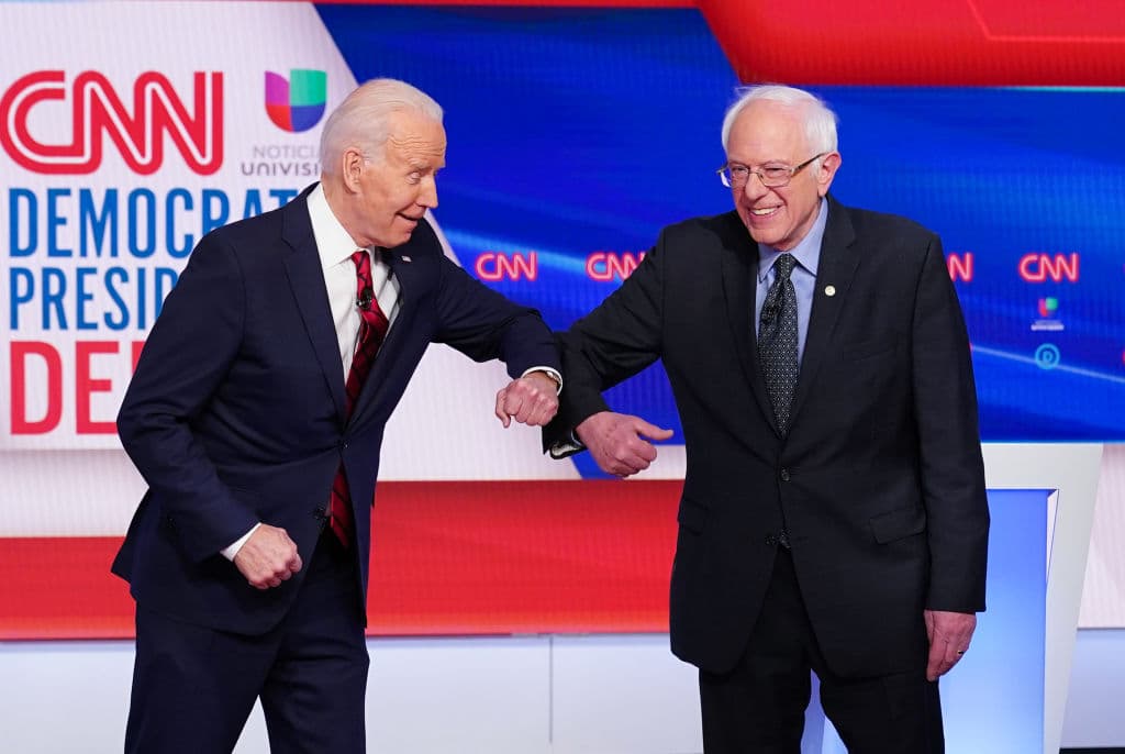 Los aspirantes presidenciales demócratas, Joe Biden y Bernie Sanders, se saludan con un golpe en el codo en el 11 ° debate presidencial del Partido Demócrata 2020 organizado por CNN y Univision Noticias.