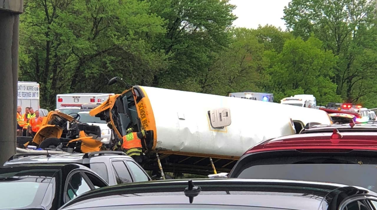Emergency personnel respond to a crash after a school bus and dump truck collided, injuring multiple people, on Interstate 80 in Mount Olive, N.J., Thursday, May 17, 2018. (Manuel Absalon via AP)