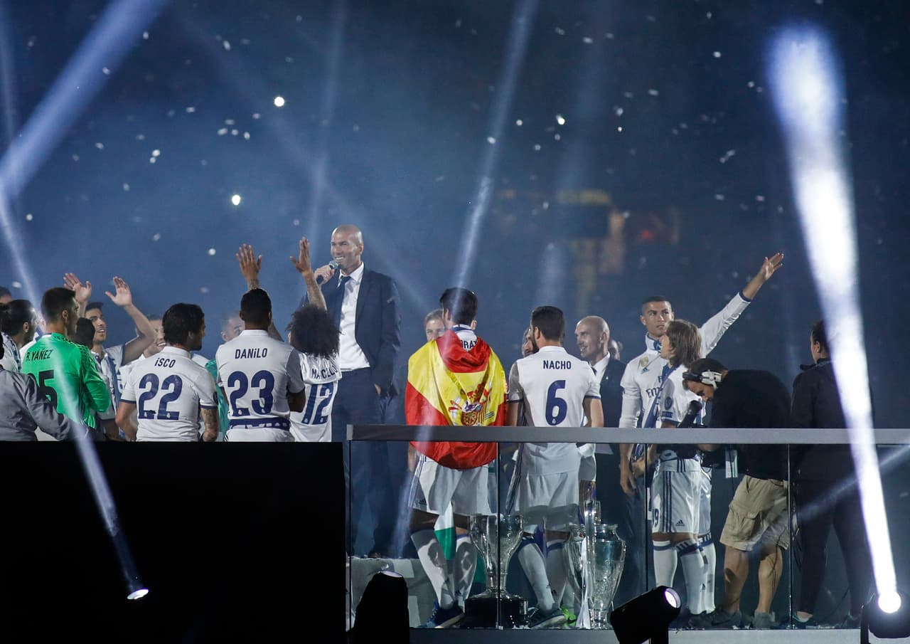 Real Madrid's French coach Zinedine Zidane speaks as he celebrates with his players the team's win, at the Santiago Bernabeu stadium in Madrid on June 4, 2017 after winning the UEFA Champions League football match final Juventus vs Real Madrid CF held at the National Stadium of Wales in Cardiff on June 3, 2017. / AFP PHOTO / OSCAR DEL POZO (Photo credit should read OSCAR DEL POZO/AFP/Getty Images)