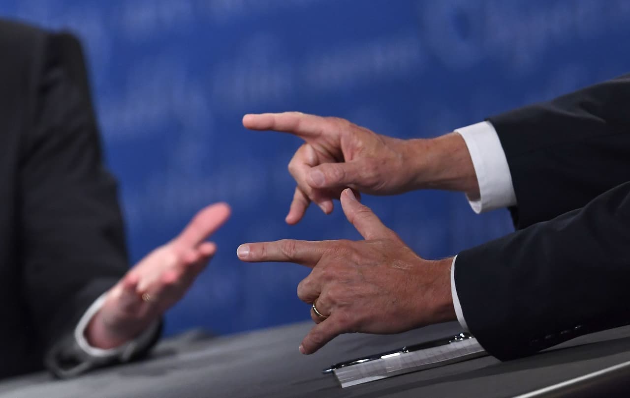 Democratic candidate for Vice President Tim Kaine (L) and Republican candidate for Vice President Mike Pence gesture during the vice presidential debate at Longwood University in Farmville, Virginia on October 4, 2016. / AFP / Jewel SAMAD (Photo credit should read JEWEL SAMAD/AFP/Getty Images)