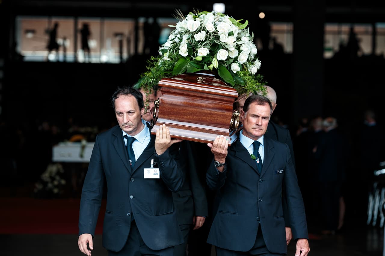 GENOA, ITALY - AUGUST 18: Coffins are carried out following a State funeral service for victims of the Morandi Bridge disaster at the Fiera di Genova exhibition centre on August 18, 2018 in Genoa, Italy. At least 38 people were killed and five remain missing after a large section of the Morandi highway bridge collapsed on August 14, 2018. Many of the victims' families declined the state funeral, with some reportedly holding government responsible for the accident. (Photo by Jack Taylor/Getty Images)