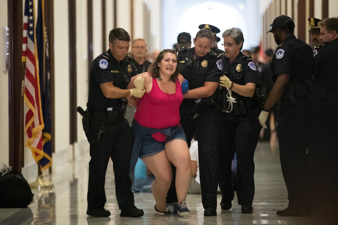 <b>Contra la reforma de salud (28 de junio).</b> Una manifestante es arrestada frente a las oficinas de senadores republicanos en el congreso. Parte de las decenas de activistas que
<b><a href="https://www.univision.com/noticias/politica/el-voto-que-salvo-a-obamacare-la-rebelion-de-john-mccain-contra-trump-que-suena-a-venganza">protestaron por la reforma a obamacare impulsada por Donald Trump, pero que aún logró pasar en el Senado. </a></b>