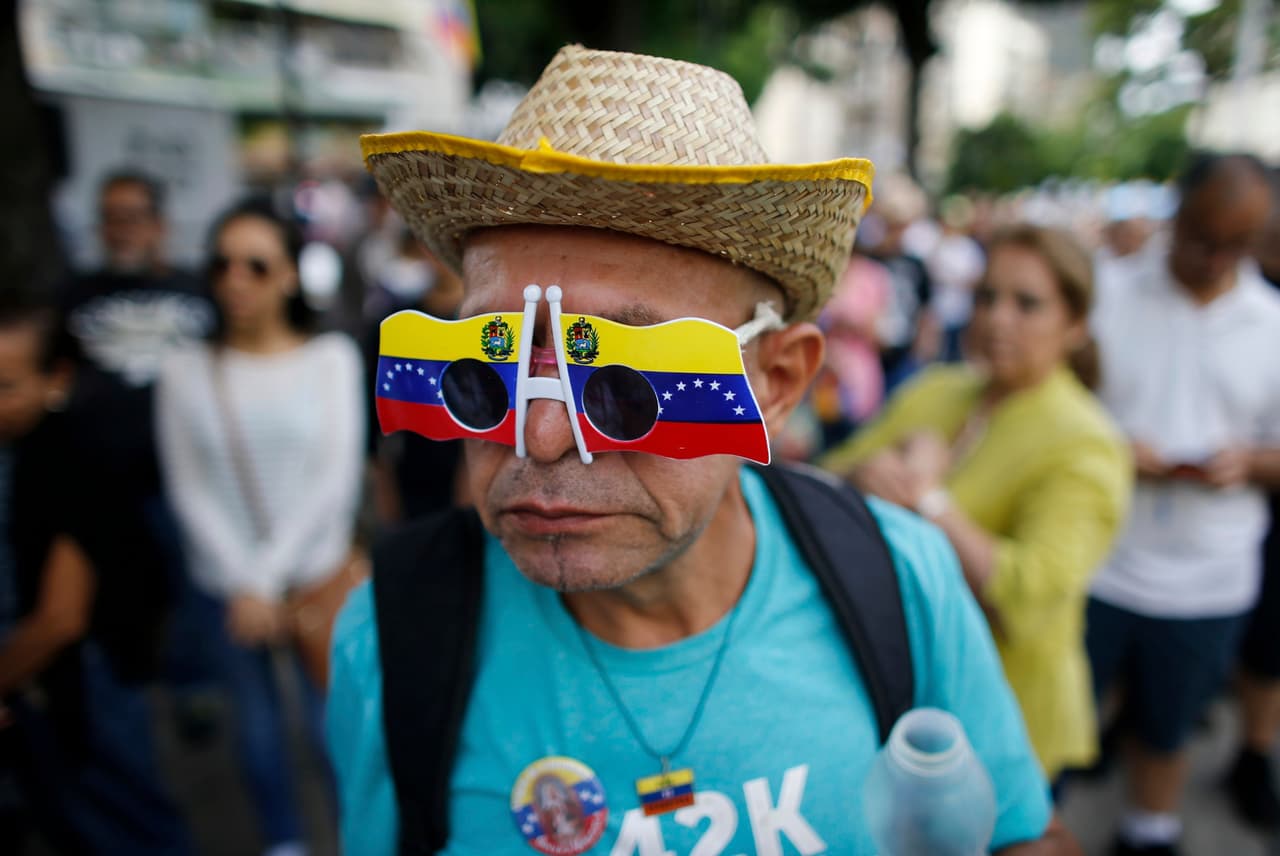 Un activista opositor en una fila para votar en la consulta organizada por la oposición. El proceso, calificado como "consulta interna" de los partidos opositores por parte del chavismo, pregunta a los venezolanos si rechazan la Asamblea Nacional Constituyente que debe elegirse el próximo 30 de julio