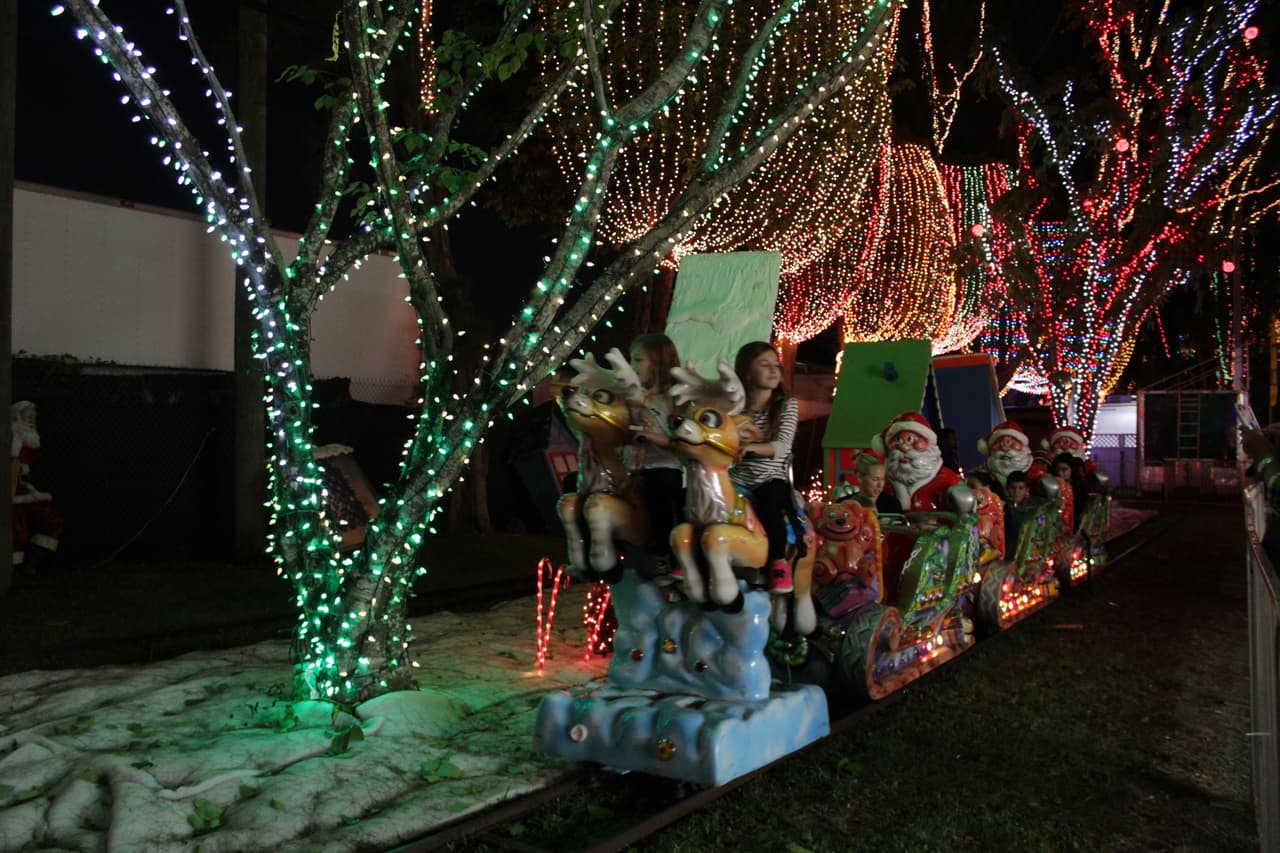 Grandes y chicos disfrutan durante la época navideña de la decoración y luces decorativas en el Santa's Enchanted Forest.