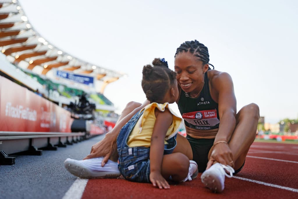 Se convirtió en la atleta olímpica de pista y campo de Estados Unidos más condecorada cuando ganó la undécima medalla de su carrera en los Juegos Olímpicos de Tokio 2020; es inspiración para las madres después de que regresó a la pista, tras dar a luz en noviembre de 2018.