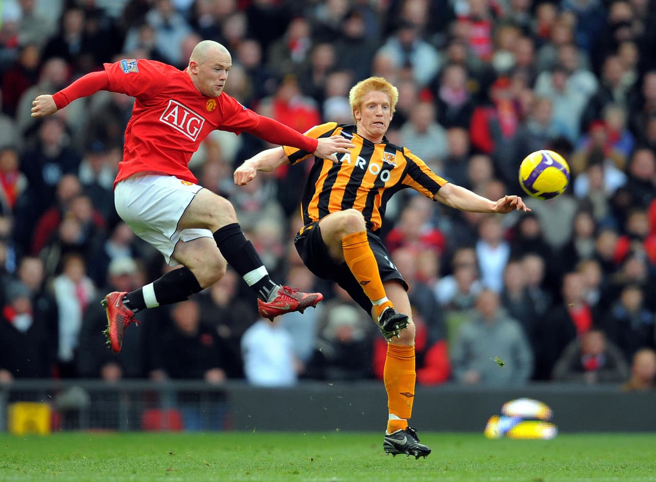 Manchester United's English forward Wayne Rooney (L) vies with Hull City's Irish defender Paul McShane during the English Premier league football match at Old Trafford, in Manchester on November 1 2008. AFP PHOTO/ANDREW YATES Mobile and website use of domestic English football pictures are subject to obtaining a Photographic End User Licence from Football DataCo Ltd Tel : +44 (0) 207 864 9121 or e-mail accreditations@football-dataco.com - applies to Premier and Football League matches. (Photo credit should read ANDREW YATES/AFP/Getty Images)