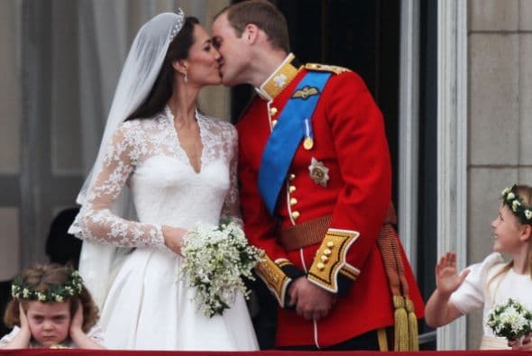 El príncipe William lbesa a la duquesa de Cambridge en el balcón del Palacio de Buckingham.