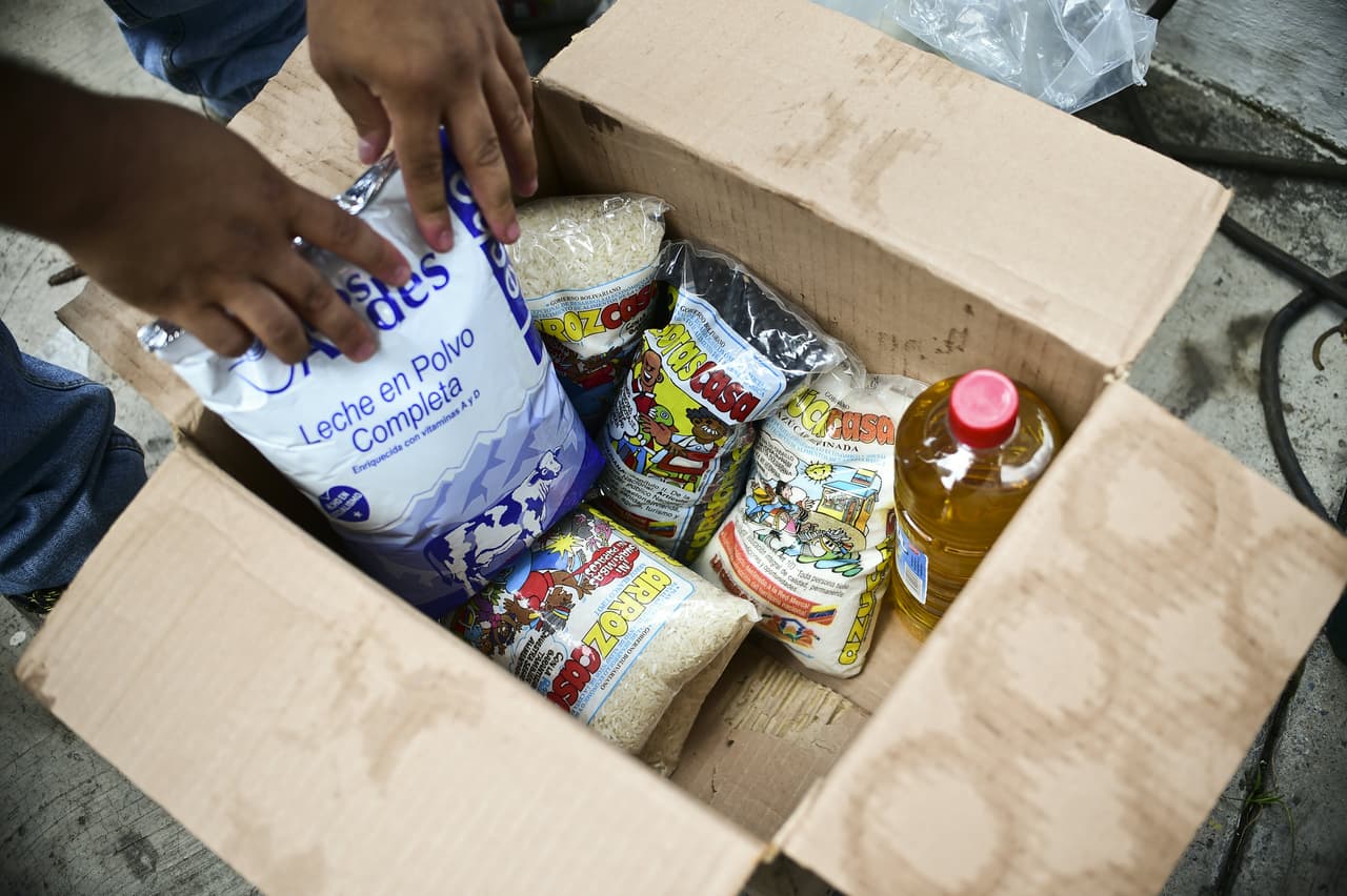 A box with basic foodstuffs is pictured in one of the food distribution centers called CLAP (Local Committees for Supply and Production), which are headed by community leaders, in the poor neighbourhood of 23 de Enero, in Caracas, on June 4, 2016. Shortages of basic goods have fueled looting, violent crime and vigilante justice. At least 94 looting sprees broke out in the first four months of the year, according to the Venezuelan Observatory for Social Conflict. Venezuela, home to the world's largest oil reserves, has been hit hard by the collapse in global crude prices over the past two years. The economy is forecast to contract eight percent this year, with inflation of 700 percent. / AFP / RONALDO SCHEMIDT (Photo credit should read RONALDO SCHEMIDT/AFP/Getty Images)