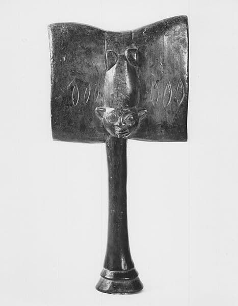 Su receptáculo es una vasija de madera, preferentemente de cedro, con tapa, que se sitúa arriba de un pilón que muchas veces puede tener forma de castillo. Sus atributos principales son seis herramientas hechas en cedro. Hachas, espadas, rayos, tambores, una mano de caracoles, corona, copa, un sable, maraca de güira y una maza.