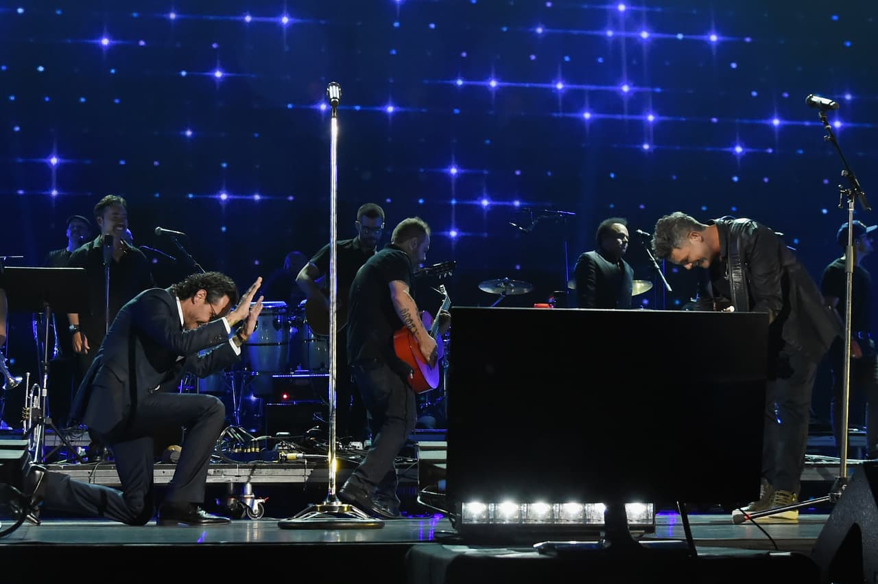 MIAMI, FL - OCTOBER 14: In this handout photo provided by One Voice: Somos Live!, Marc Anthony and Alejandro Sanz perform onstage at One Voice: Somos Live! A Concert For Disaster Relief at Marlins Park on October 14, 2017 in Miami, Florida. (Photo by Rick Diamond/One Voice: Somos Live!/Getty Images)