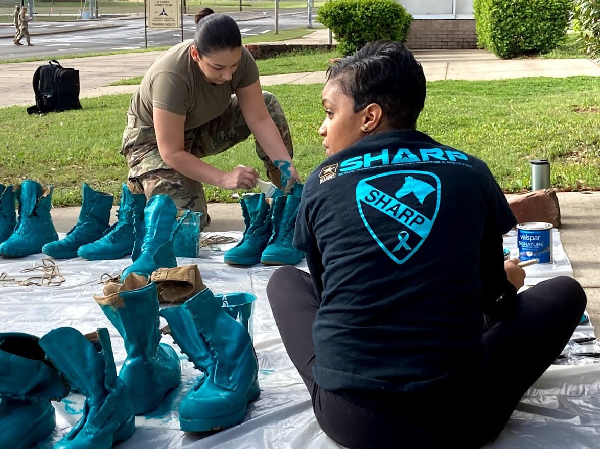 Members of the Army sexual abuse prevention program (SHARP) at Fort Hod, Texas, paint boots with the color teal to mark Sexual Assault Awareness Month in April. "This is about getting us back to what we are supposed to be," says Kyomi Carpenter, a Victim Advocate for 1st Cavalry Brigade.