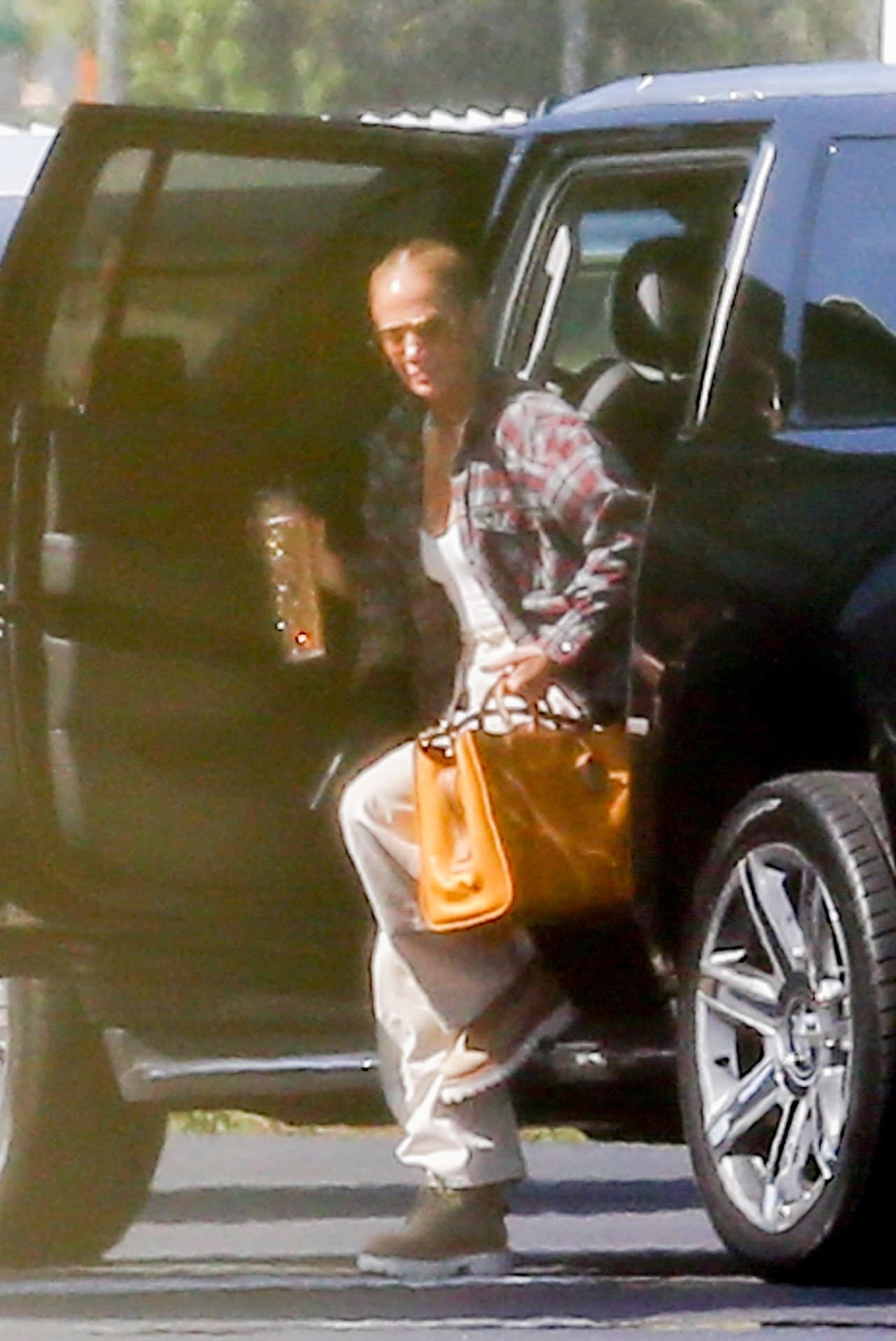 Para su viaje, la celebridad eligió vestir de color blanco. Una camisa de franela complementó su look, en el que combinó un top, pantalones cargo y botas.