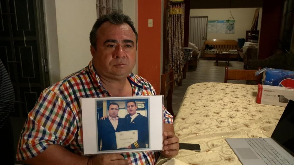 Néstor Clavijo shows a photo with his son disappeared in the Peruvian jungle.