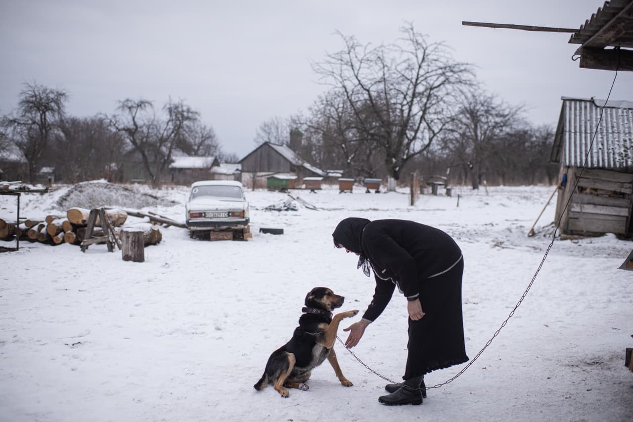 Hanna Bespalko, 54, juega con su perro Botsia mientras se celebra en la casa familiar, en Bila Krysytsia, un servicio por su hijo Denys Hrynchuk, que sirvió en el ejército ucraniano y murió el 28 de febrero cerca de Volnovaja, en la 
<a href="https://www.univision.com/noticias/mundo/invasion-de-ucrania-como-fue-el-ataque-de-rusia-putin">región de Donetsk.</a>