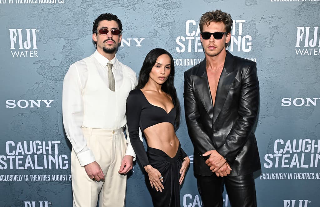 Benito Antonio Martinez Ocasio (aka Bad Bunny), left, Zoe Kravitz and Austin Butler attend the premiere of "Caught Stealing" at Regal Union Square on Tuesday, Aug. 26, 2025, in New York. (Photo by Evan Agostini/Invision/AP)