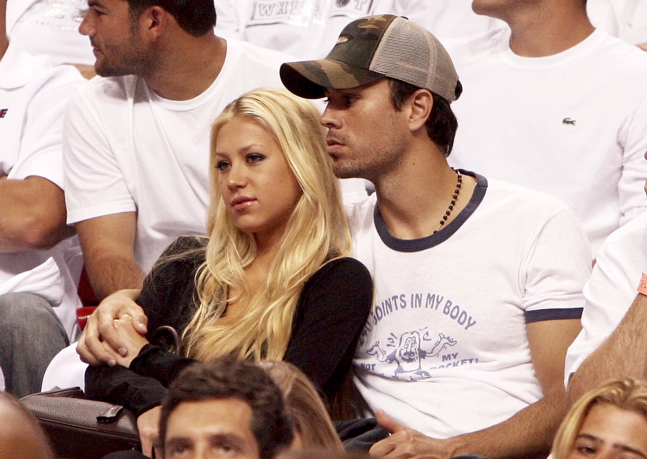 MIAMI - MAY 8: Former Tennis player Anna Kournikova and singer Enrique Iglesias hold each other as they watch the the New Jersey Nets take on the Miami Heat in game one of the Eastern Conference semifinals at American Airlines Arena on May 8, 2006 in Miami, Florida. The Nets defeated the Heat 100-88. NOTE TO USER: User expressly acknowledges and agrees that, by downloading and/or using this Photograph, user is consenting to the terms and conditions of the Getty Images License Agreement. (Photo by Doug Benc/Getty Images)