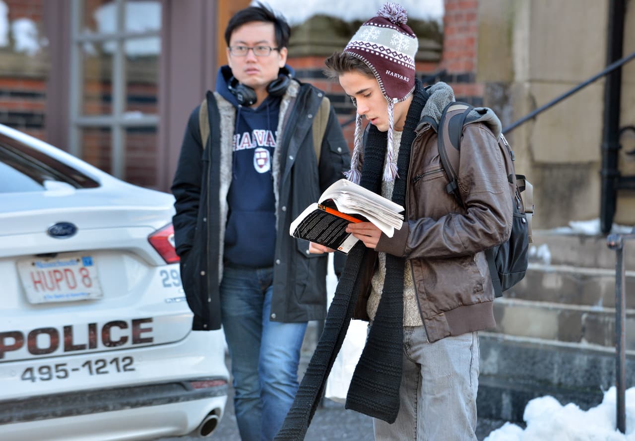 Students wait outside a building at Harvard University in Cambridge, Mass., Monday, Dec. 16, 2013. Four buildings on campus were evacuated Monday after campus police received an unconfirmed report that explosives may have been placed inside, interrupting final exams. (AP Photo/Josh Reynolds)