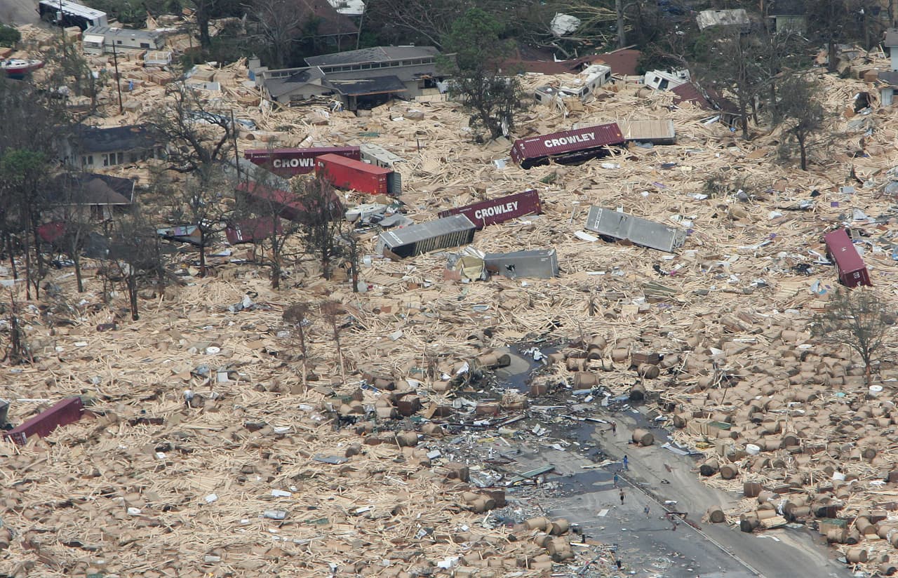 A residental area is engulfed in shipping containers, RVs, and boats washed ashore 30 August 2005 in Gulfport, Mississippi following high winds and waves Hurricane Katrina. At least 80 people were feared dead along the coast of the southern state of Mississippi, where glitzy casinos, plush homes and shrimp fishing businesses lay in ruins, after a storm surge up to 30 feet (10 metres) high crashed ashore 29 August 2005. (Photo credit should read PAUL J. RICHARDS/AFP/Getty Images)