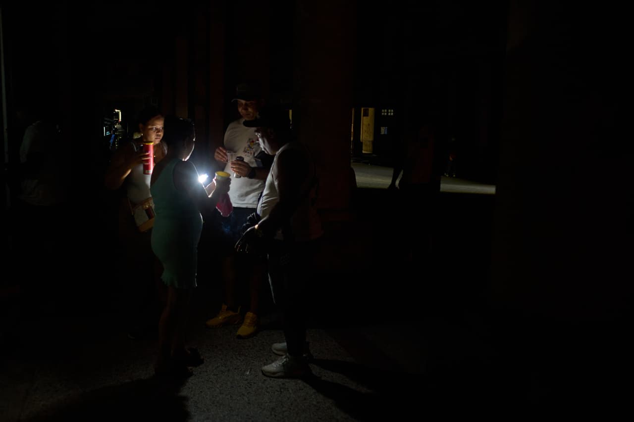 People spend time on a street during a blackout in Havana, Cuba, Monday, July 6, 2026. (AP Photo/Ramon Espinosa)