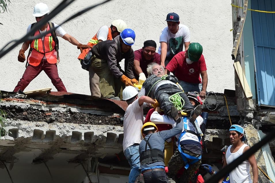An injured Mexico City earthquake survivor is carried to safety.