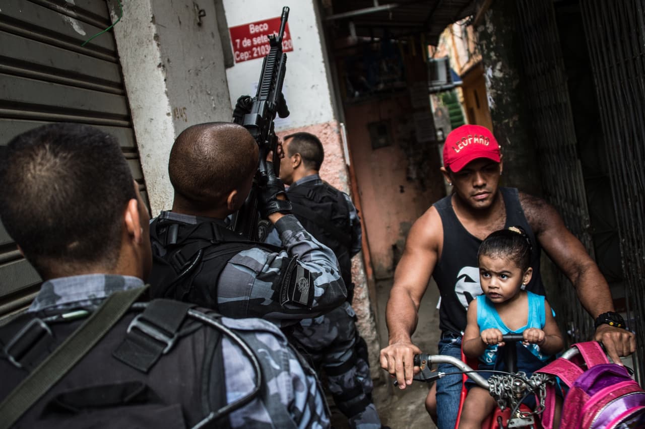 Military police patrol the Praia da Ramos and Roquette Pinto communities in Rio de Janeiro, Brazil, on April 1, 2015.