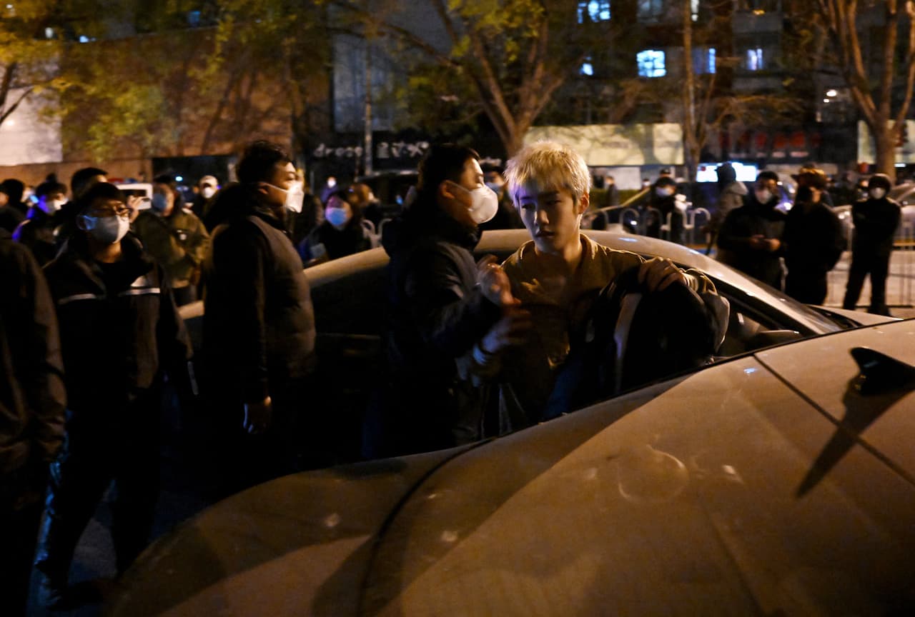 Un manifestante es detenido por la policía durante una de las protestas en Beijing contra las medidas de confinamiento.