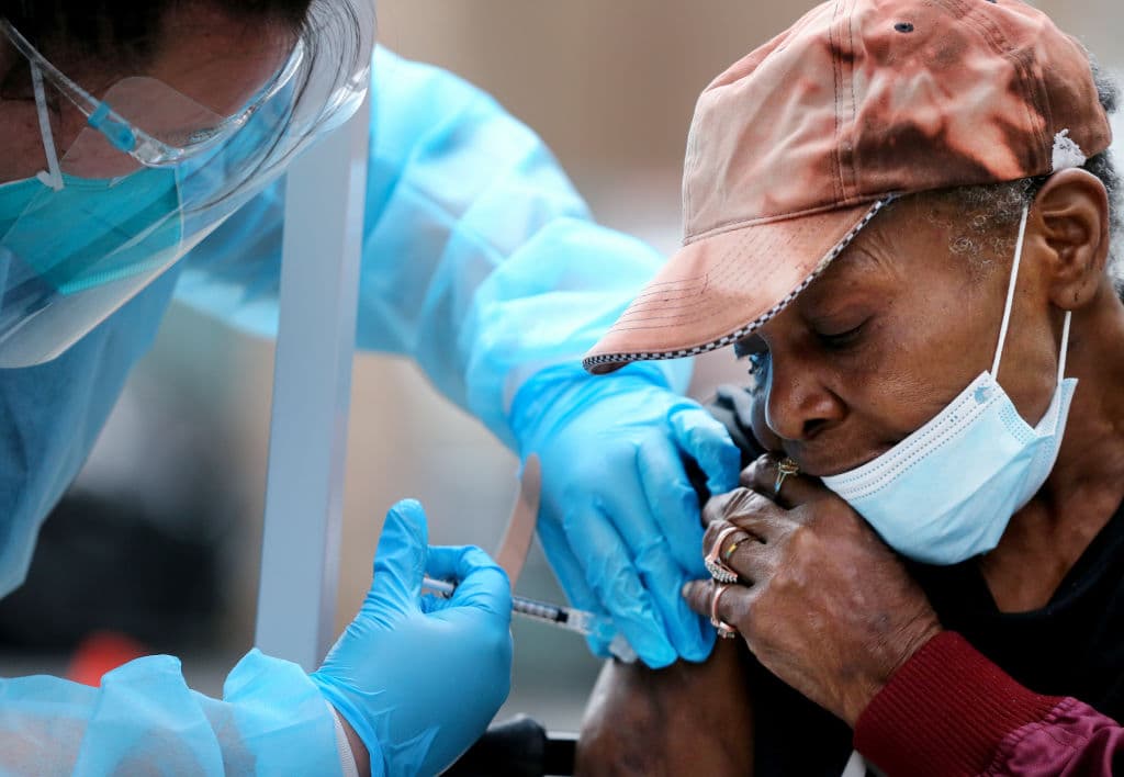Viola, 75, receives a dose of the Moderna covid-19 vaccine from a healthcare worker outside the Los Angeles Mission located in the Skid Row community on February 10, 2021 in Los Angeles, California. Skid Row is home to thousands of people who either live on the streets or in shelters for the homeless.