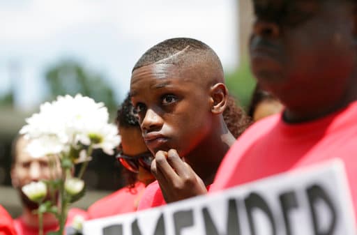 A young person looks on during a protest for slain teen Jordan Edwards outside the court house in Dallas, Saturday, May 13, 2017. (AP Photo/LM Otero)