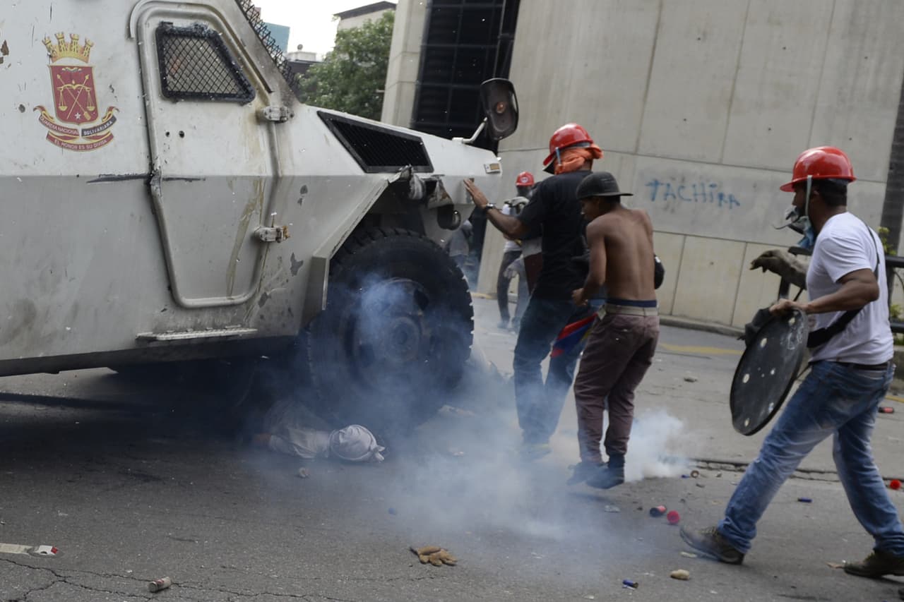 A National Guard riot control armored vehicle rolled over a group of opposition protesters. One of them was trapped under the vehicle. the person's condition is not known. May 3, 2017