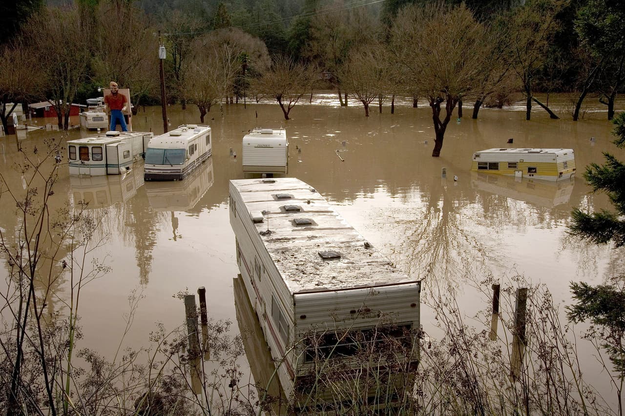 GUERNEVILLE, CA - JANUARY 2: Trailers and motor homes located at the River Bend Trailer Park sit in the water from a flood on January 2, 2006 in Guerneville, California. Northern California has been inundated by heavy rain over the past week, causing mudslides and rivers to spill over their banks. (Photo by David Paul Morris/Getty Images)