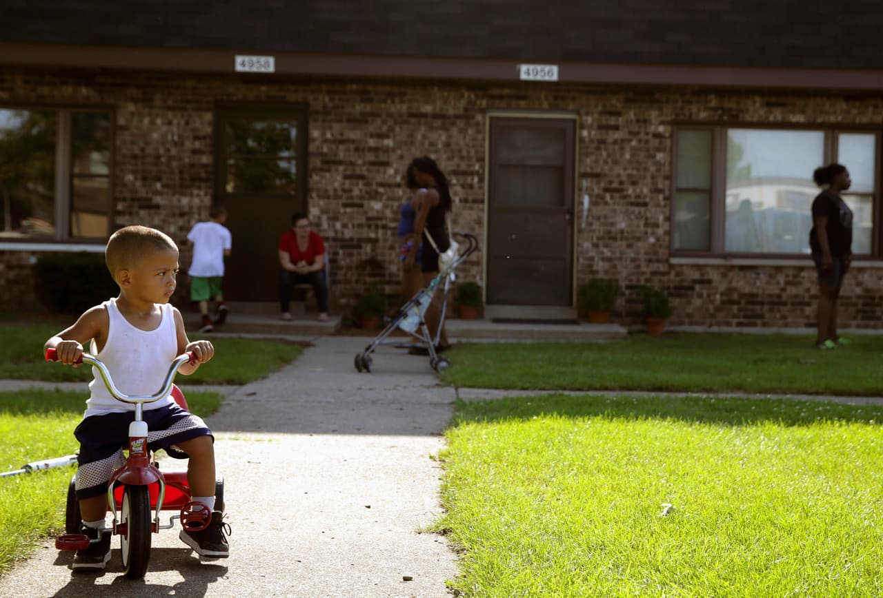 FILE - In this Aug. 3, 2016 file photo, Joseph Russell, 2, rides his tricycle outside his home at the West Calumet Housing Complex in East Chicago, Ind. The mayor of this industrial town ordered the evacuation of the 40-year-old public housing complex this summer because of severe lead contamination, forcing more than 1,000 people from their homes.(Jonathan Miano/The Times via AP, file)