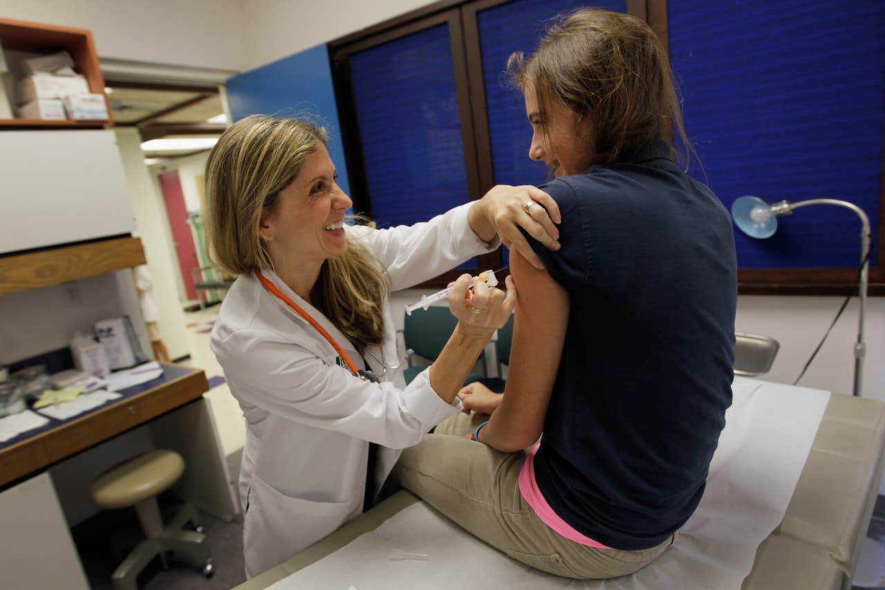 MIAMI, FL - SEPTEMBER 21: University of Miami pediatrician Judith L. Schaechter, M.D. (L) gives an HPV vaccination to a 13-year-old girl in her office at the Miller School of Medicine on September 21, 2011 in Miami, Florida. The vaccine for human papillomavirus, or HPV, is given to prevent a sexually transmitted infection that can cause cancer. Recently the issue of the vaccination came up during the Republican race for president when Rep. Michele Bachmann (R-MN) called the vaccine to prevent cervical cancer "dangerous" and said that it may cause mental retardation, but expert opinion in the medical field contradicts her claim. Texas Gov. Rick Perry, also a presidential contender, has taken heat from some within his party for presiding over a vaccination program in his home state. (Photo by Joe Raedle/Getty Images)