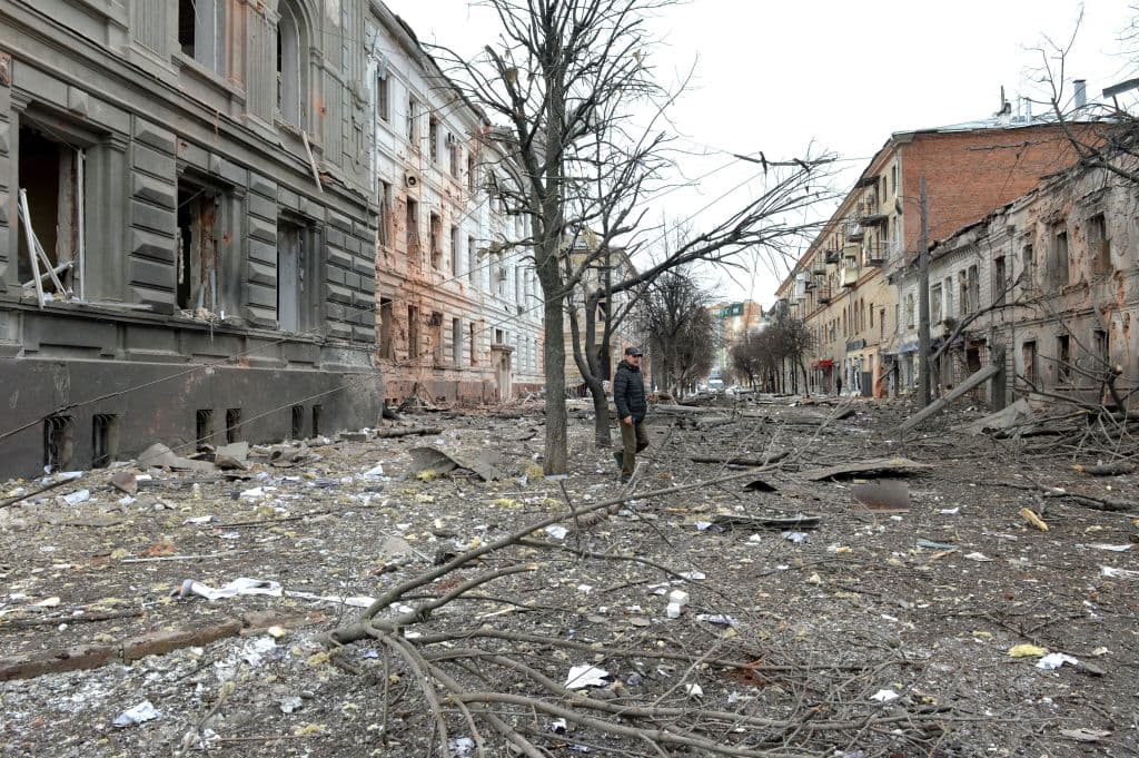 A pedestrian walks amid debris in a street following a shelling in Ukraine's second-biggest city of Kharkiv on March 7, 2022.