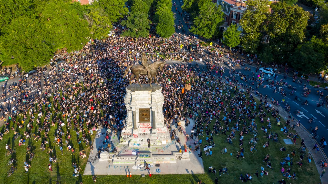 Manifestantes rodean la estatua del general confederado Robert E. Lee, un monumento que fue vandalizado en las protestas de Richmond el 2 de junio. Ralph Northam, gobernador de Virginia, anunció que esta polémica estatua, la más grande de un confederado en el estado, será retirada.
<br>