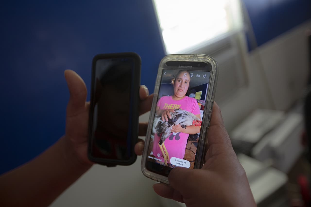 Felix shows on his cell phone a photograph of his wife Crescencia, now detained in Louisiana.