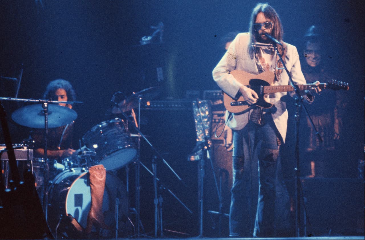 Neil Young performs on stage at the Rainbow Theatre with The Santa Monica Flyers, Ralph Molina on drums, London, 5th November 1973.