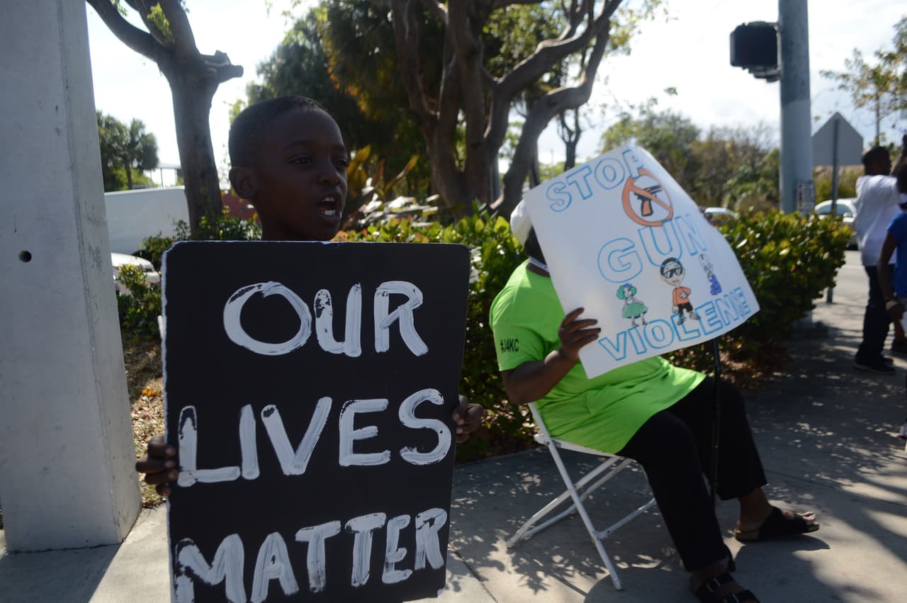 Robert Carr, 8, says "Our lives matter,' at protest over gun violence in Miami April 28