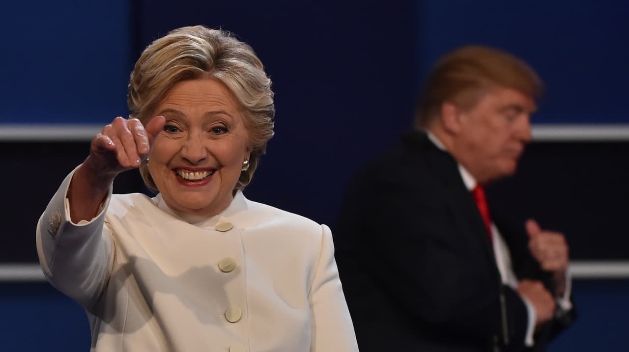 Democratic presidential nominee Hillary Clinton waves from the stage following the third and final US presidential debate with Republican nominee Donald Trump (background) at the Thomas & Mack Center on the campus of the University of Las Vegas in Las Vegas, Nevada on October 19, 2016. / AFP / Paul J. Richards (Photo credit should read PAUL J. RICHARDS/AFP/Getty Images)