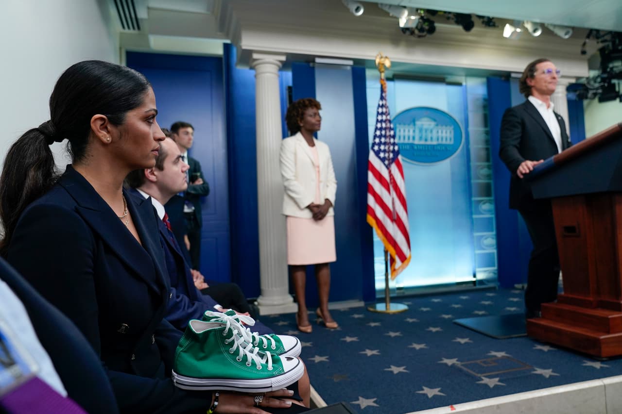 Camila Alves McConaughey holds the lime green Converse tennis shoes that were worn by Uvalde shooting victim Maite Yuleana Rodriguez, 10, as Matthew McConaughey, a native of Uvalde, Texas, joins White House press secretary Karine Jean-Pierre for the daily briefing at the White House in Washington, Tuesday, June 7, 2022. (AP Photo/Susan Walsh)