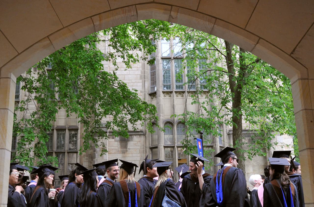 FILE - In this May 24, 2010 file photo, future graduates wait for the procession to begin for commencement at Yale University in New Haven, Conn. The U.S. Education Department said in a letter to the Asian American Coalition for Education on Wednesday, Sept. 26, 2018, that it will investigate 2016 allegations of discrimination against Asian-American applicants at Yale. The complaint from the New Jersey-based coalition says Yale, Brown University and Dartmouth College unfairly denied Asian-American applicants by treating them differently based on their race. The Education Department said it had enough information to investigate Yale.(AP Photo/Jessica Hill)
