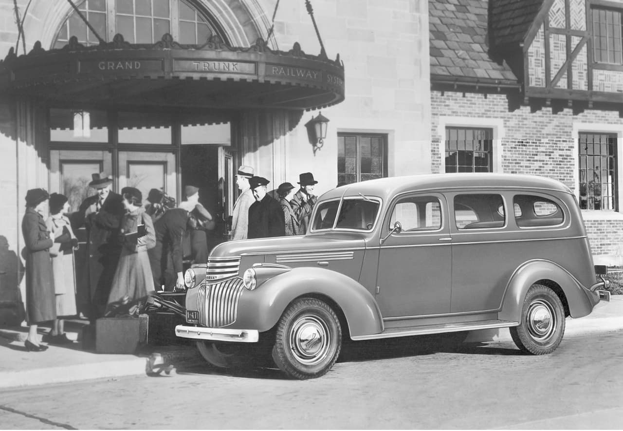 <b>Generación 1 (1935-1940)</b>
<br>
<br>La Suburban Carryall llega en 1935 con un chasis de media tonelada y un diseño de dos puertas. Su motor era un 'Stovebolt' de 6 cilindros en línea con la capacidad de generar 60 caballos de fuerza. En 1937, el diseño de esta primera generación adopta elementos Art Deco y su mecánica incrementa su caballaje en 19 unidades de potencia.
<br>
<br>
<b>En imagen:</b> Chevrolet Suburban 1937