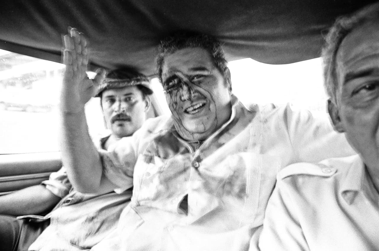 Guillermo Endara, future president of Panama, on his way to the hospital after he was beaten by pro-Noriega mob in Panama City, May 10, 1989