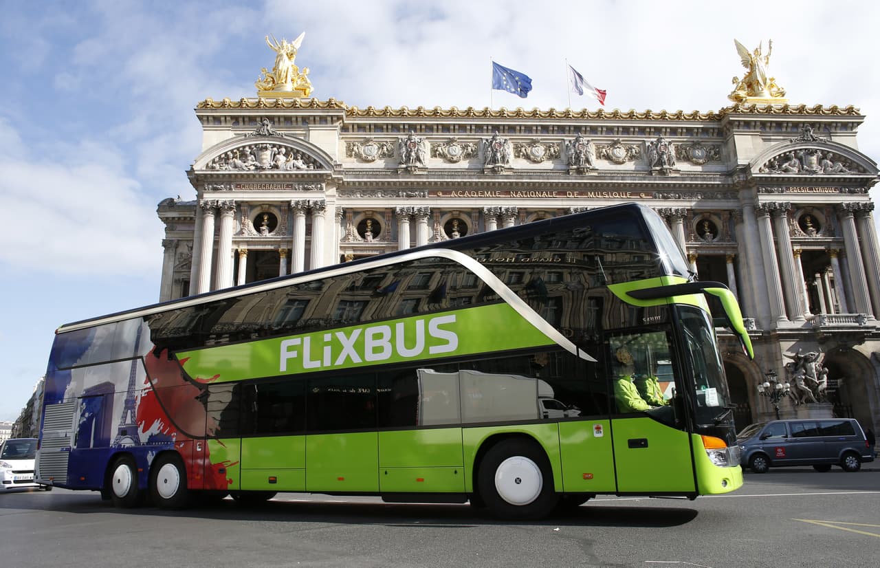 A bus of the German intercity bus service FlixBus drives past the Palais Garnier opera house on May 19, 2015 in Paris. The leader in transport services by bus in Germany, the start-up Flixbus, launched its services in Paris on May 19, 2015. The company now operates in 15 European countries. AFP PHOTO / THOMAS SAMON (Photo credit should read THOMAS SAMSON/AFP/Getty Images)