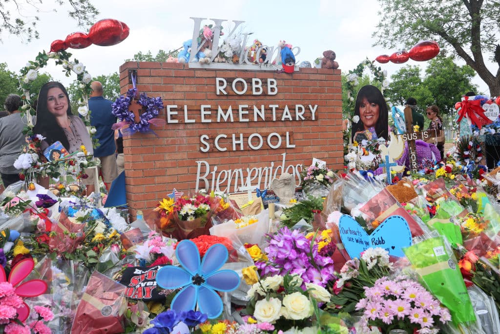 UVALDE, TEXAS - MAY 30: People visit a memorial for the 19 children and two adults killed on May 24th during a mass shooting at Robb Elementary School on May 30, 2022 in Uvalde, Texas. Visitations for Amerie Jo Garza and Maite Rodriguez, two of the 19 children killed in the May 24th Robb Elementary School mass shooting are being held today. Wakes and funerals for the 21 victims will be scheduled throughout the week. (Photo by Michael M. Santiago/Getty Images)
