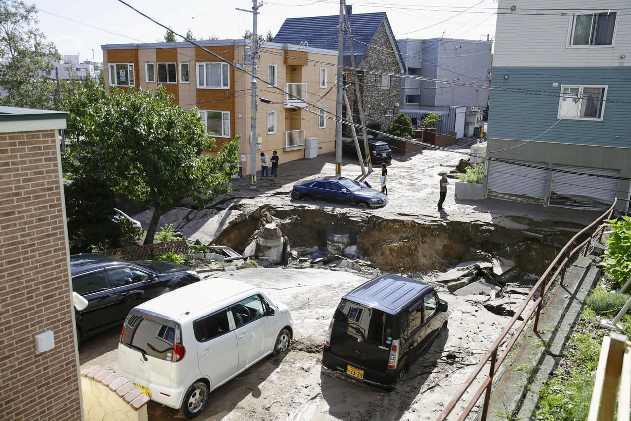 People look at an area damaged by an earthquake in Sapporo in Japan's northern island of Hokkaido, Japan, in this photo taken by Kyodo September 6, 2018. Mandatory credit Kyodo/via REUTERS ATTENTION EDITORS - THIS IMAGE WAS PROVIDED BY A THIRD PARTY. MANDATORY CREDIT. JAPAN OUT. NO COMMERCIAL OR EDITORIAL SALES IN JAPAN.