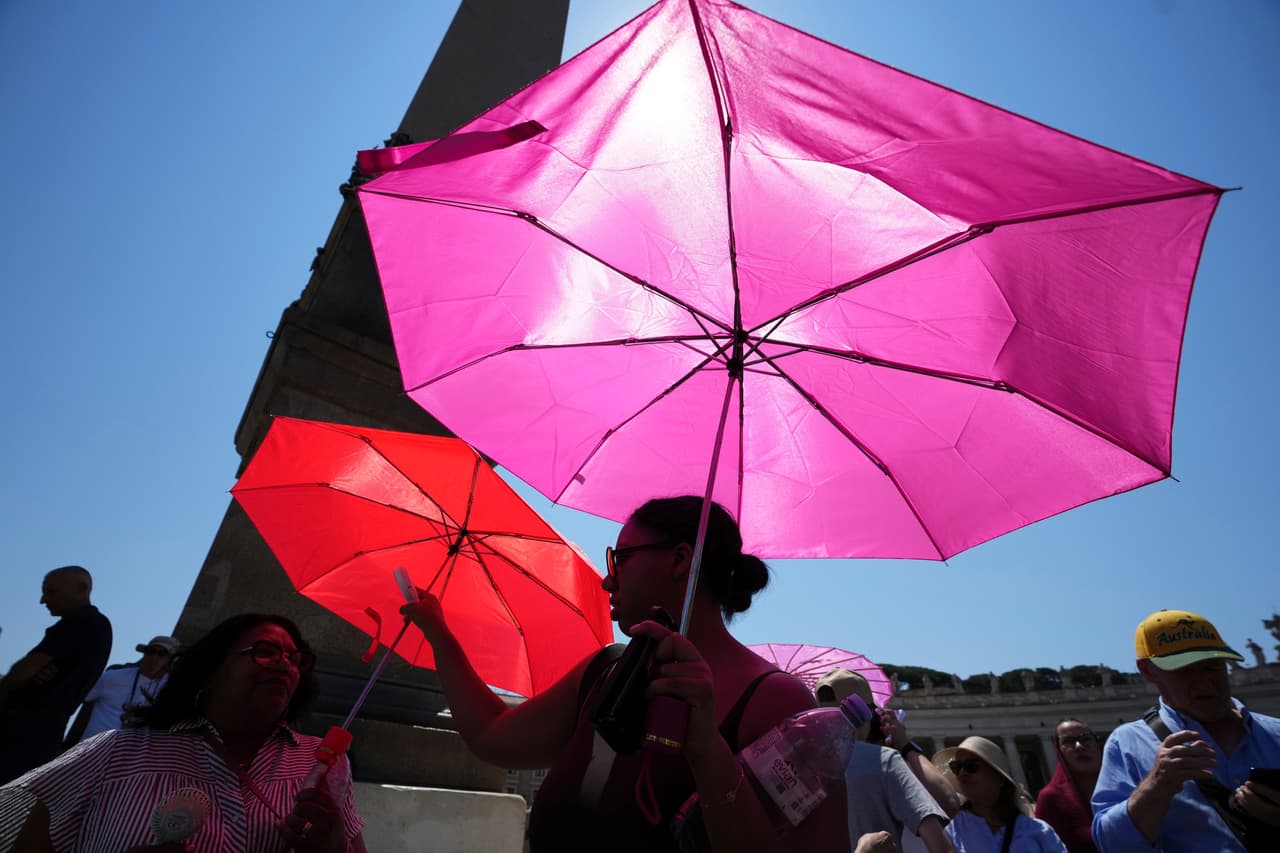 People shelter from sun with umbrellas as they wait for the Angelus noon prayer celebrated by Pope Leo XIV from the window of his studio overlooking St.Peter's Square, at the Vatican, Sunday, June 28, 2026. (AP Photo/Alessandra Tarantino)